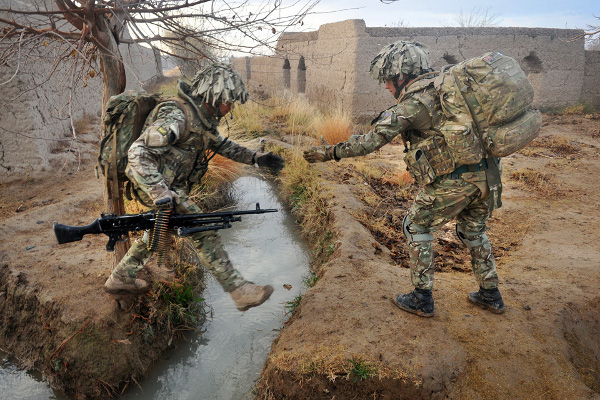 CAPTION:CORRUNA COMPANY, THE 1st BATTALION THE DUKE OF LANCASTERÕS REGIMENT (1 LANCS) DEPLOY ON OPERATION QALB 11 Deploying repeatedly on the ground in the lower Nahr-E-Sahraj district as part of Operation QALB 11, the soldiers of 2 Platoon, Corrunna Company (Coy), 1 LANCS kept up the pressure of patrolling onto insurgent held ground. Letting their Afghan allies, the Afghan Uniformed Police (AUP), lead the way, they supported and advised to take the emphasis off the building of a new bridge in a spot where the Taliban had previously destroyed an old one. The patrolling was a success with repeated IED finds by the AUP who destroyed them in place. They also confiscated or destroyed items used by insurgents as they went along searching compounds in the area, which were known to be used as firing points or places for Insurgents to live. In this image: A helping hand, the ground in Afghan is hard as it is dangerous, with many obstaclesa to cross. Please Credit Photographer.